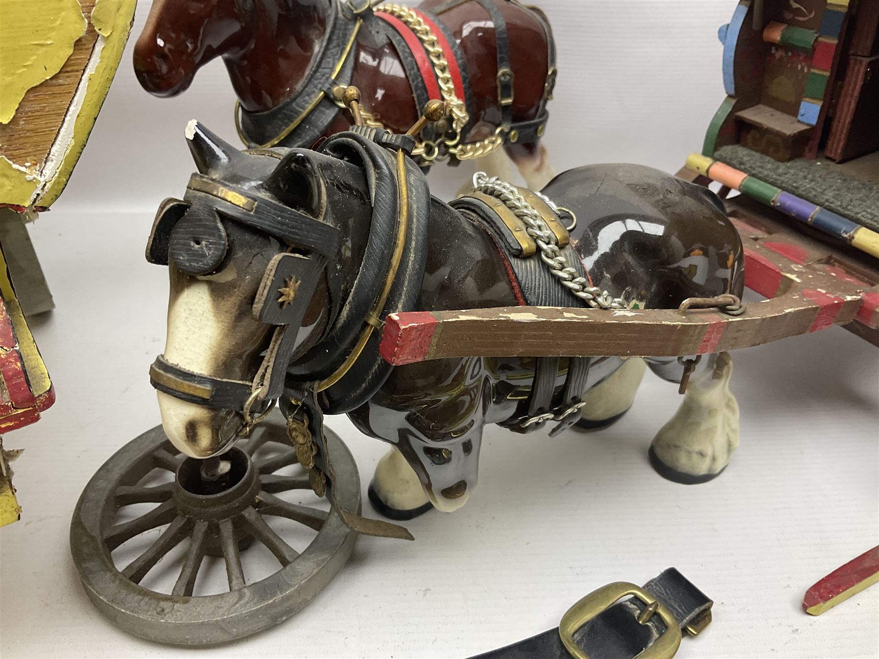 Two ceramic shire horse and gypsy caravans, together with horse brasses 