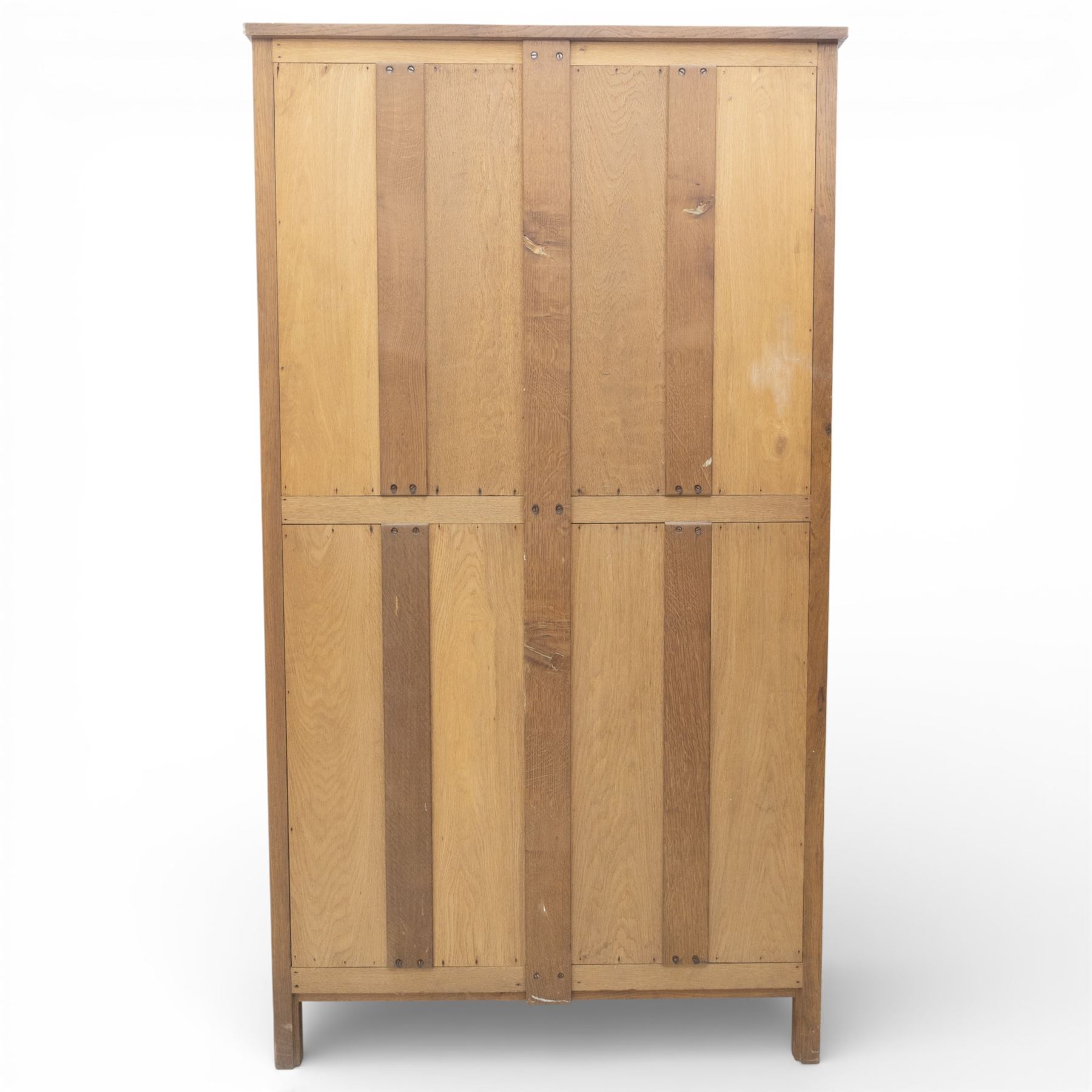 Acornman - oak adzed panelled double wardrobe, with wrought iron hinges and carved oak latch revealing a single clothes rail, with signature carved acorn to top left, by the workshop of Alan Grainger, Brandsby