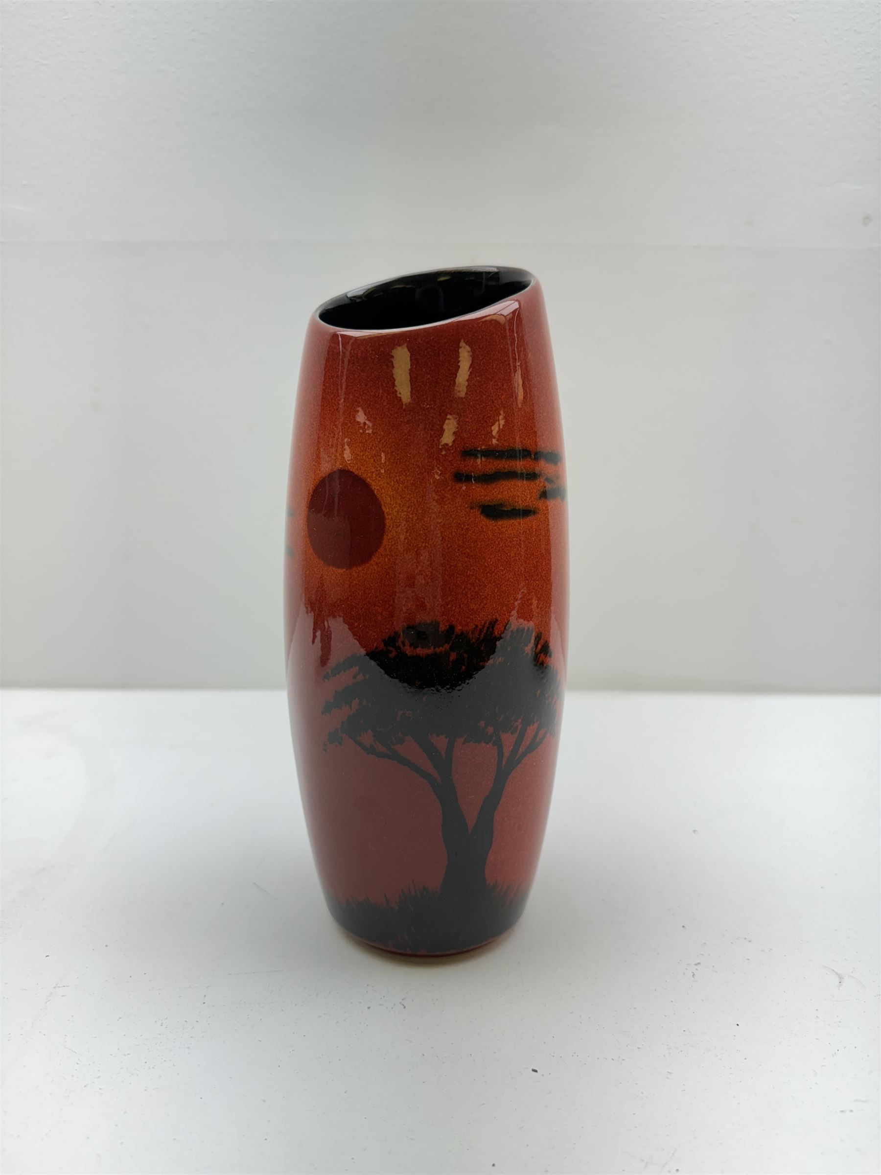 Poole pottery Form vase by Andrew Tanner, decorated with a silhouette of a tree beneath a red sun, together another with Poole pottery vase and dolphin, largest H24cm 