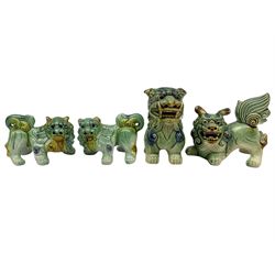 Group of four Chinese Foo dog in traditional green, blue and ochre glaze, largest 14cm