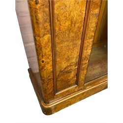 Victorian walnut wardrobe, projecting cavetto cornice over banded frieze, fitted with central door with arched bevelled mirror plate flanked by arch panels with moulded slips, enclosing brass hanging rail and hooks