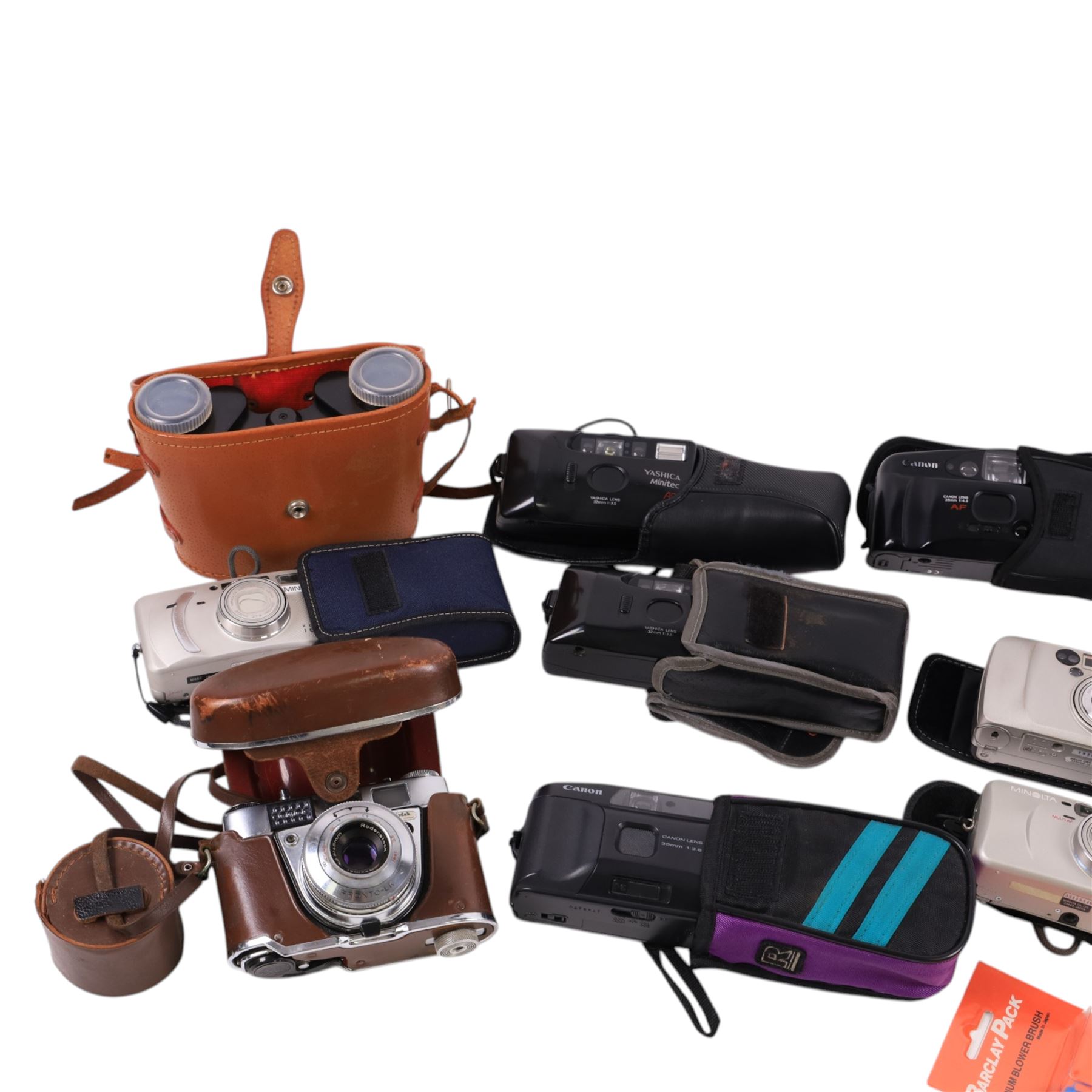 Collection of compact cameras, including Yashica, Minolta and Praktica examples, Boots binoculars, two Pentacon lenses and other accessories