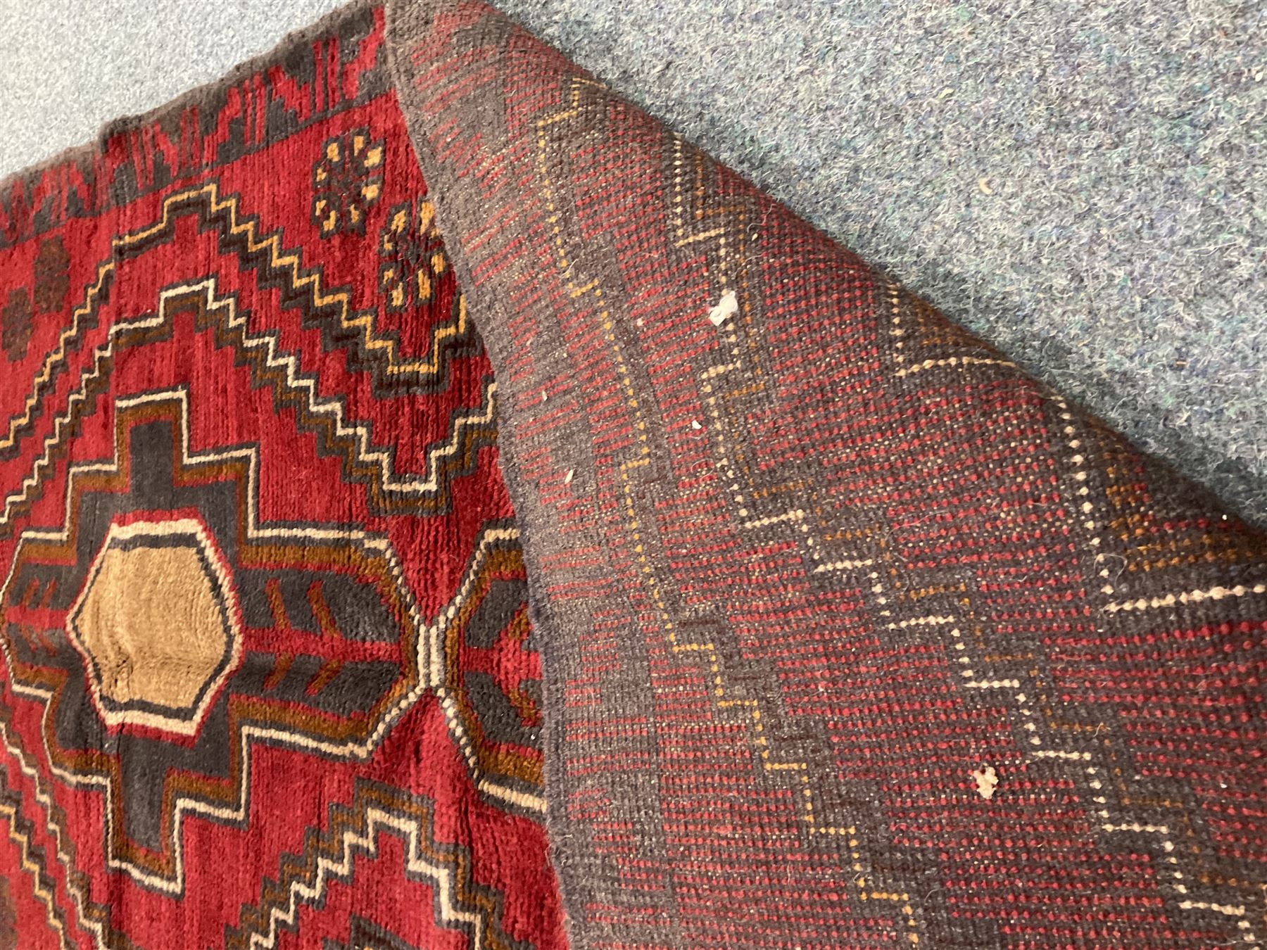 Baluchi red and blue ground rug, repeating border