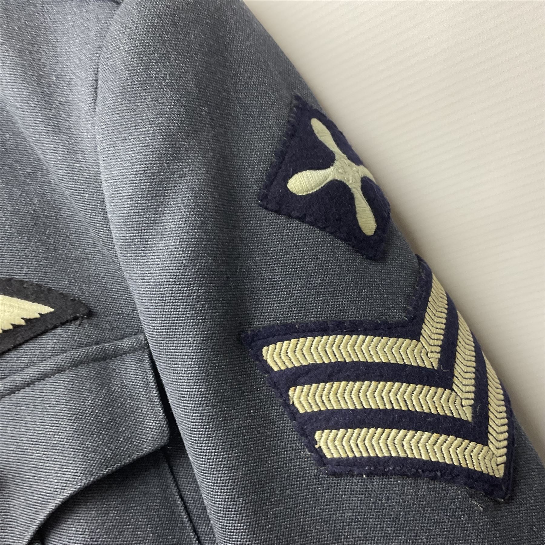 Two post-WWII British Army No.2 Dress tunics, one with Green Howards buttons; army shirt dated 1951; Royal Fleet Auxilliary jacket with trousers; three RAF/WAAF uniforms and RAF Greatcoat; and three canvas/webbing bags, two dated 1943 & 1945