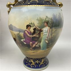 19th century Vienna style porcelain 'Musik' garniture, the central vase of baluster form with domed cover flanked by two smaller vases with twin curved gilt handles to short neck, each decorated with classical figural vignettes between blue borders heightened with gilt, H33.5cm