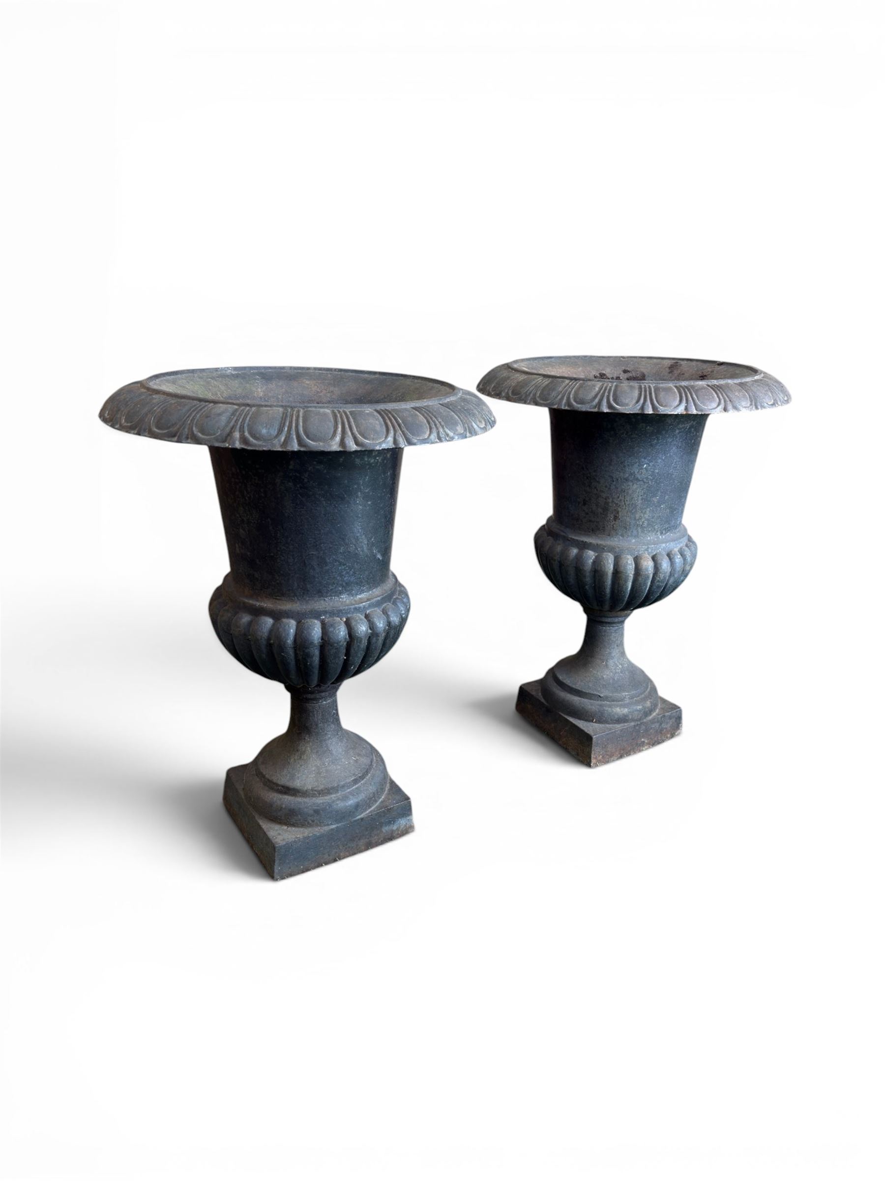 Pair of Victorian design heavy cast iron garden urns, black painted, egg and dart rim on waisted column