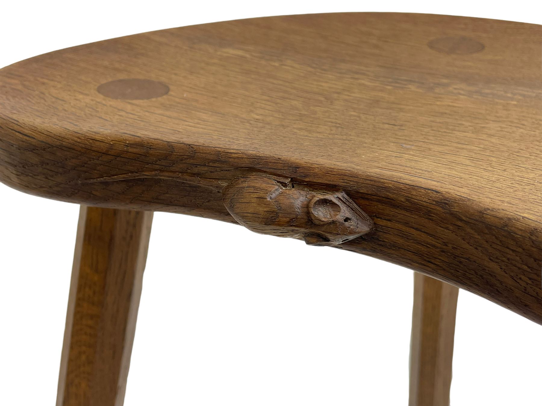 'Mouseman' oak three-legged stool, kidney shaped dished seat carved with mouse signature to edge, by Robert Thomas of Kilburn