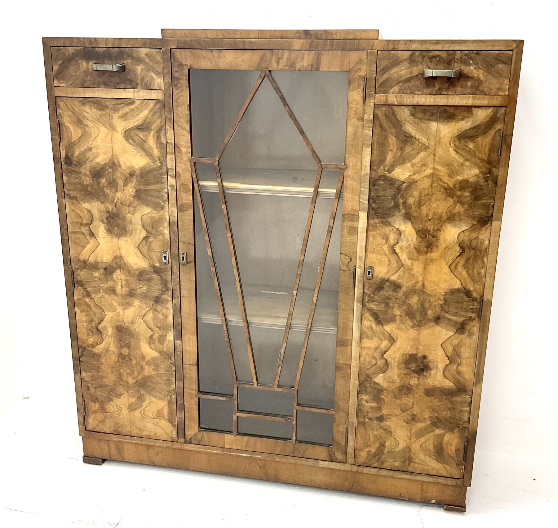 Art Deco walnut display cabinet, central astragal glazed door flanked by two drawers and two cupboards 