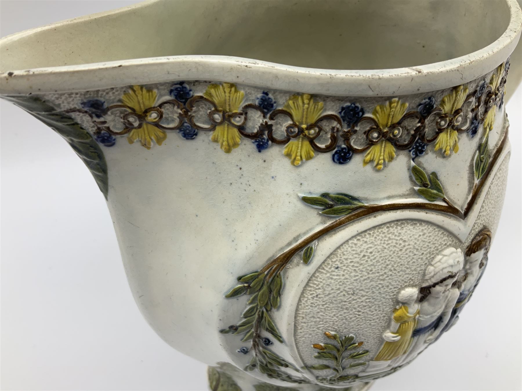 Early 19th century Prattware jug, circa 1800, decorated with two heart shaped panels of children, titled Sportive Innocence and Mischievous Sport, further decorated with acanthus and foliate borders, H22cm