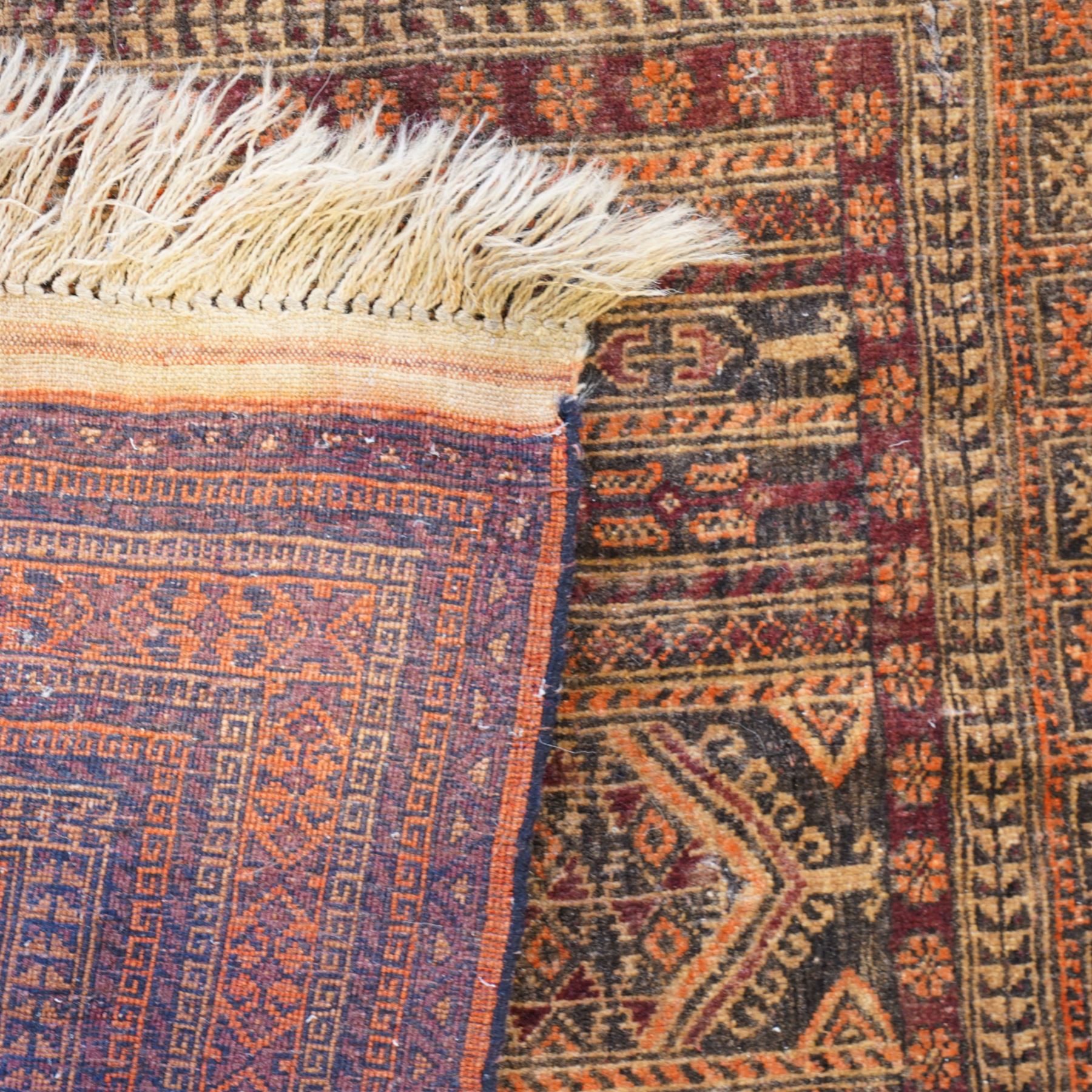 North West Persian Baluch prayer rug, central pointed mihrab design,    dark brown and camel tones, with repeating geometric and stylised floral motifs, lower field with tree of life motifs, main border geometric vine pattern in alternating colours, narrow guard stripes with repeating small motifs 