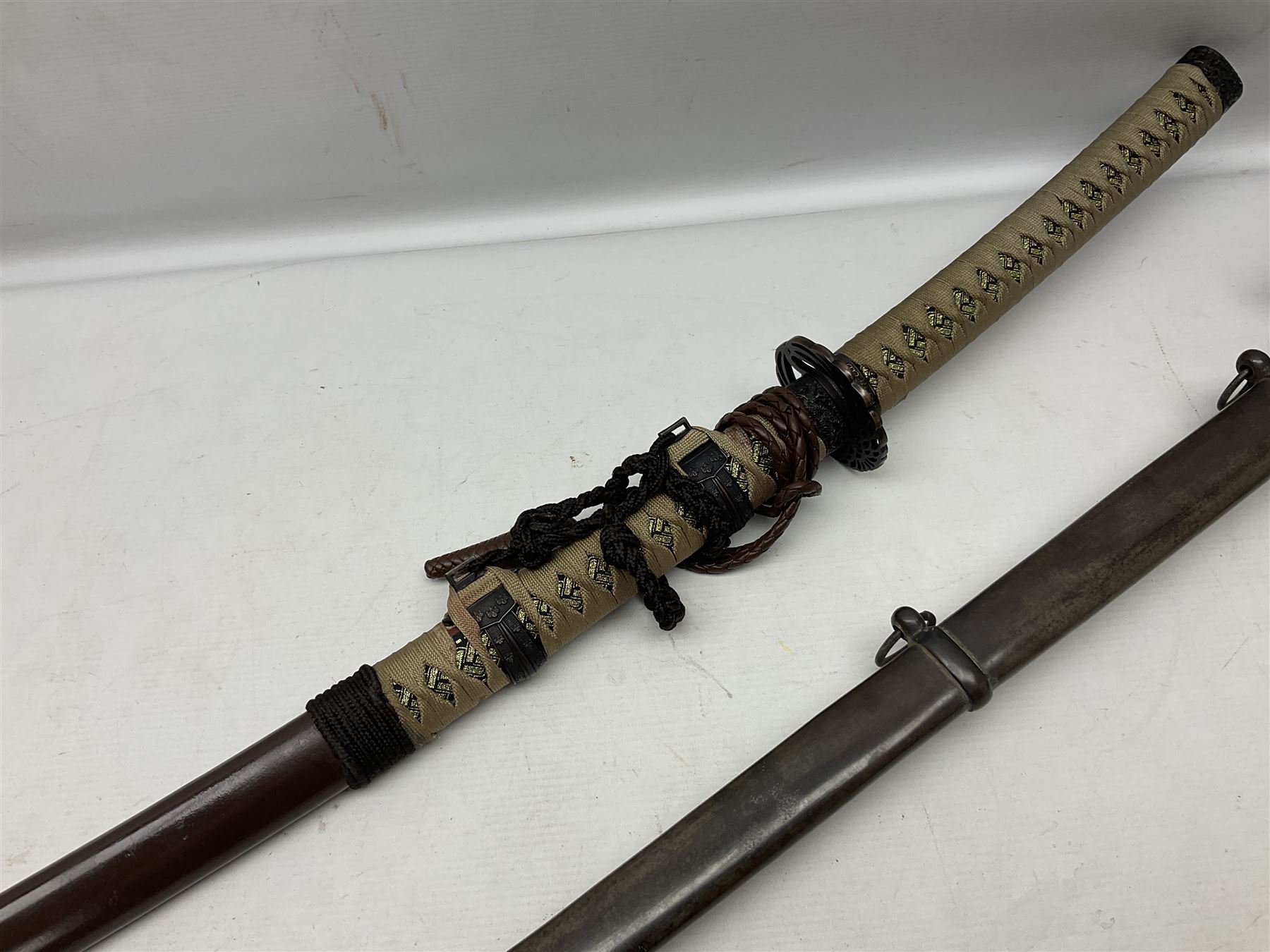 Reproduction Scottish officers basket hilt broad sword, the brass basket pierced with heart-shaped motifs lined with red lining, together with a reproduction Japanese Katana sword, longest L110cm