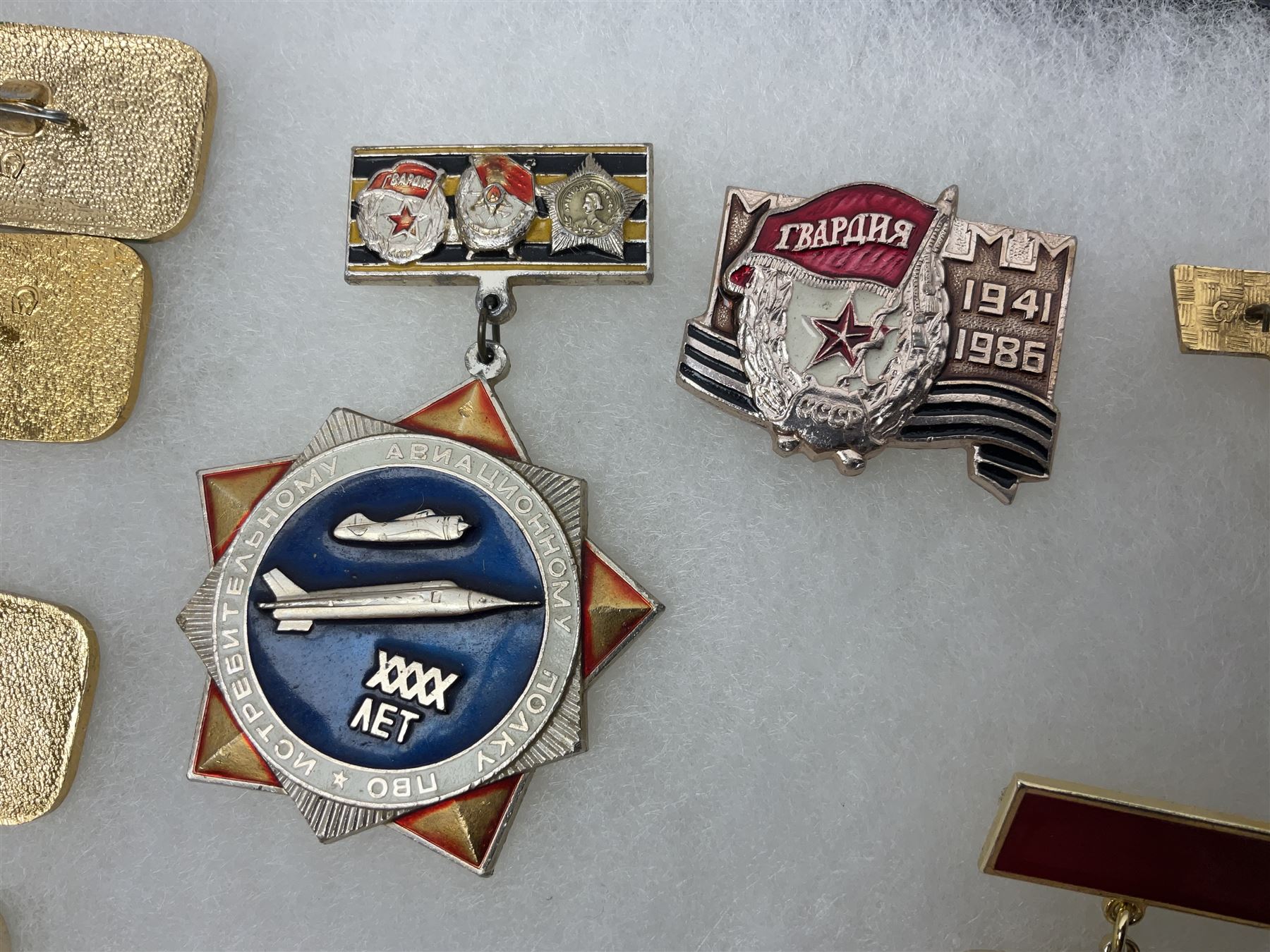 Nineteen Russian Soviet Tank Commemoration badges and medals, in small display case