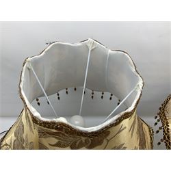 Pair bronzed amphora lamps with pineapple decoration, scroll handles and foliate base with scrolled feet together with pair peach ground shades and raised floral pattern H76cm (2)