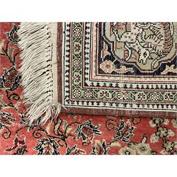Fine Persian silk and cotton hunting rug, pink ground field depicting hunting scenes, trees and flowers, the border decorated with scrolls and script panel