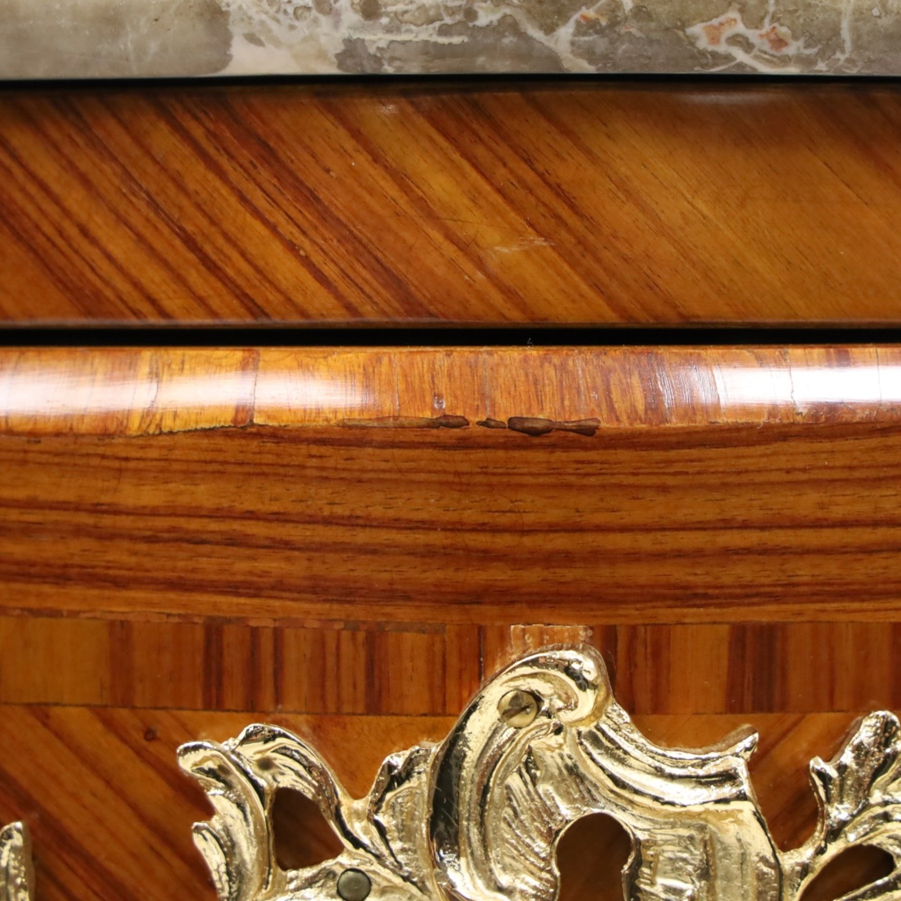 Colombo Mobili - Italian Louis XV design kingwood and marquetry bombé commode chest, the shaped marble top with moulded edge, fitted with an assortment of three shaped short drawers over two long, each with parquetry veneered facias and rocaille shaped gilt metal handles and escutcheons, flanked by gilt metal cartouche mounts with scroll and foliate detail, shaped apron on splayed bracket feet