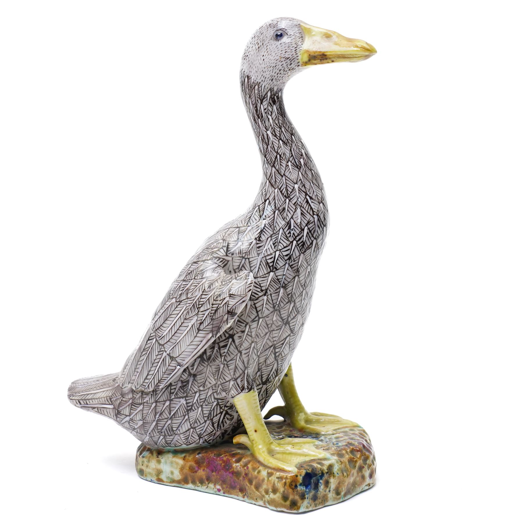 Pair of 20th century Chinese Export porcelain ducks, each naturalistically modelled with aubergine and white enamel plumage and seated on polychrome rockwork bases, H24cm 