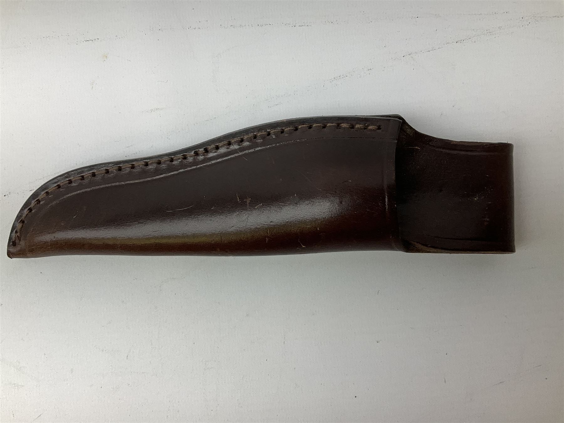 Three hunting knives, each blade marked A. Wright & Sons Sheffield, one with leather handle, one with horn handle and one with antler handle; each with leather sheath (3)