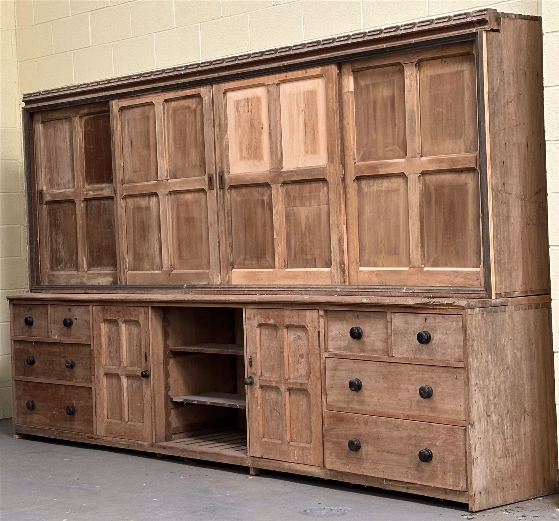 Late Victorian country house pine dresser, the four fielded panelled sliding cupboard doors opening to reveal three shelves, over a base fitted with two adjustable shelves to centre, flanked at each end with a cupboard, two short, and two long drawers, restoration and later elements. H218cm, L375cm, D62cm. - COLLECTION BY APPOINTMENT FROM: The White House, Thirsk Road, Easingwold, York, YO61 3NF - CALL 01723 507111 TO ARRANGE