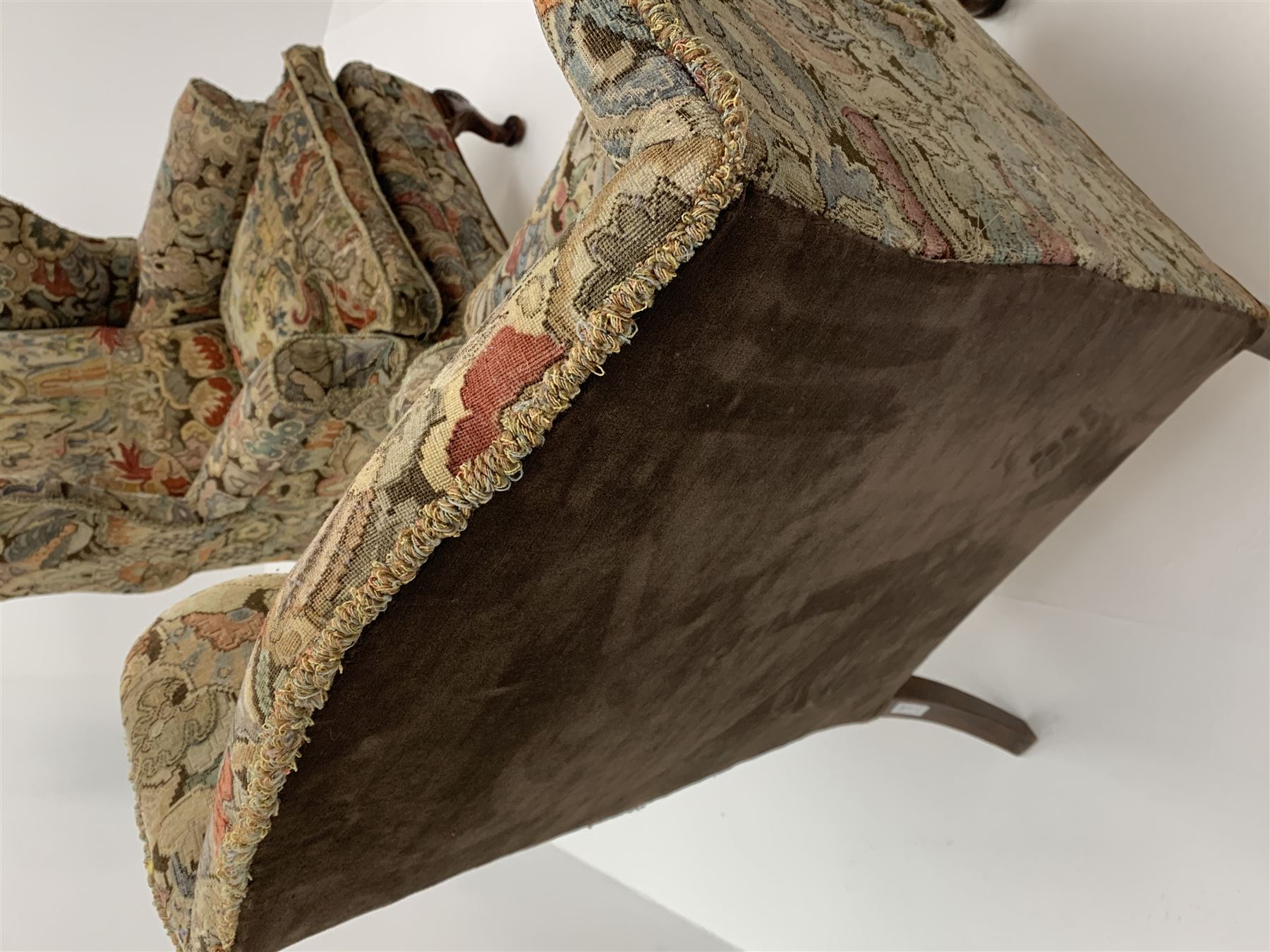 Matched pair early 20th century Queen Anne style wingback armchairs, walnut framed, sprung seats with seat cushions upholstered in needle work cover, shell carved cabriole front feet