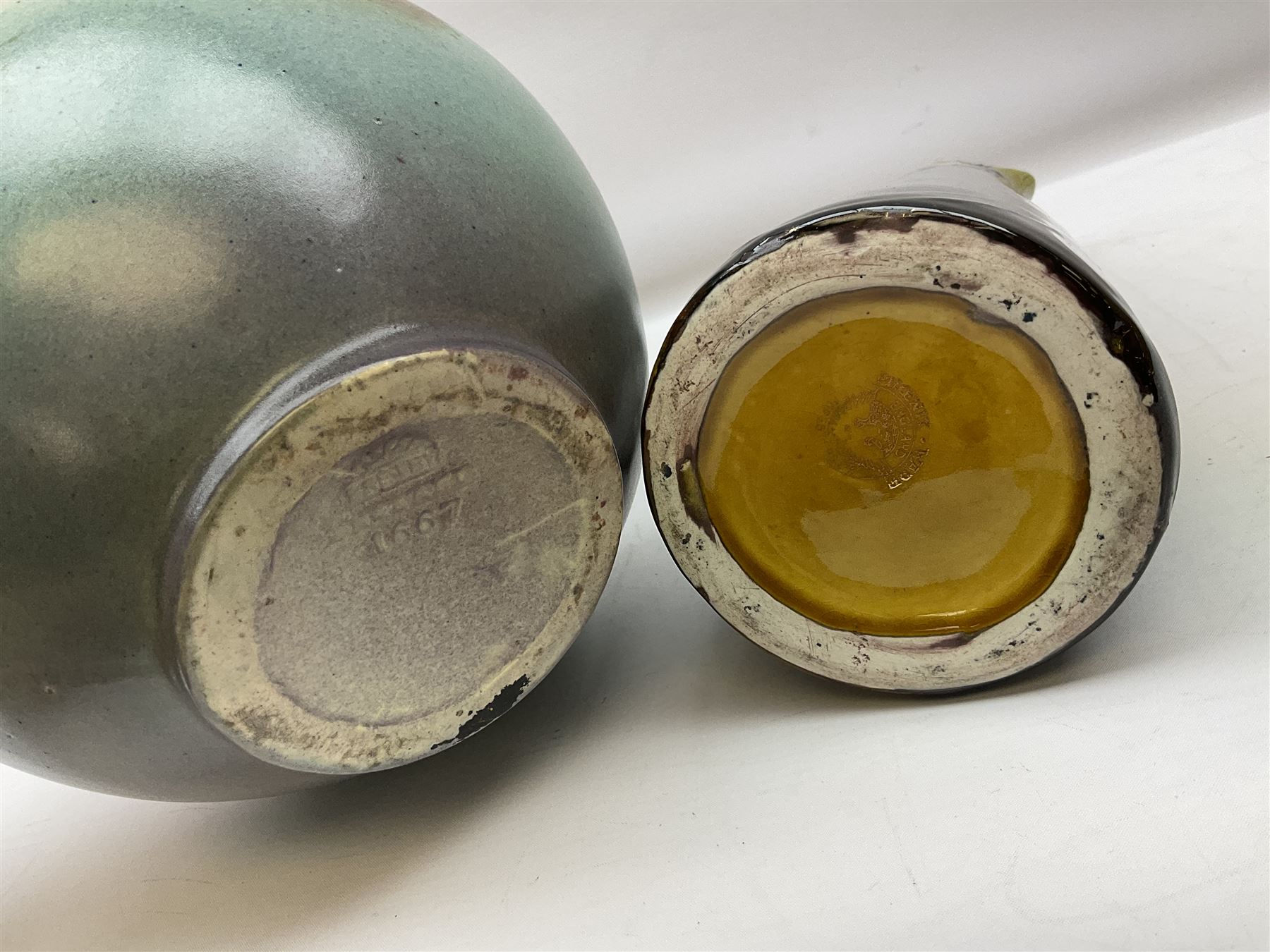 T. Forester Phoenix ware ewer of tapering form decorated with peacock and Bretby twin handled vase decorated with figures fishing in a boat sea scene