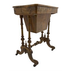 Late Victorian figured walnut sewing or work box, hinged rectangular lid inlaid with floral motifs and boxwood stringing, the interior fitted with central lidded compartment and smaller divisions, on turned pillar supports united by turned stretchers, on splayed acanthus carved feet