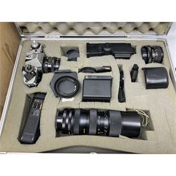 Canon AE-1 camera body, with various lens and other camera equipment, housed in hard case