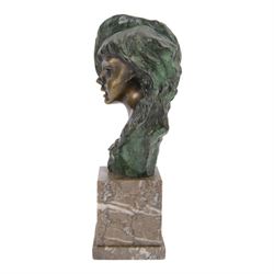Bronze bust of a boy wearing a hat, upon a stepped marble base, H37cm