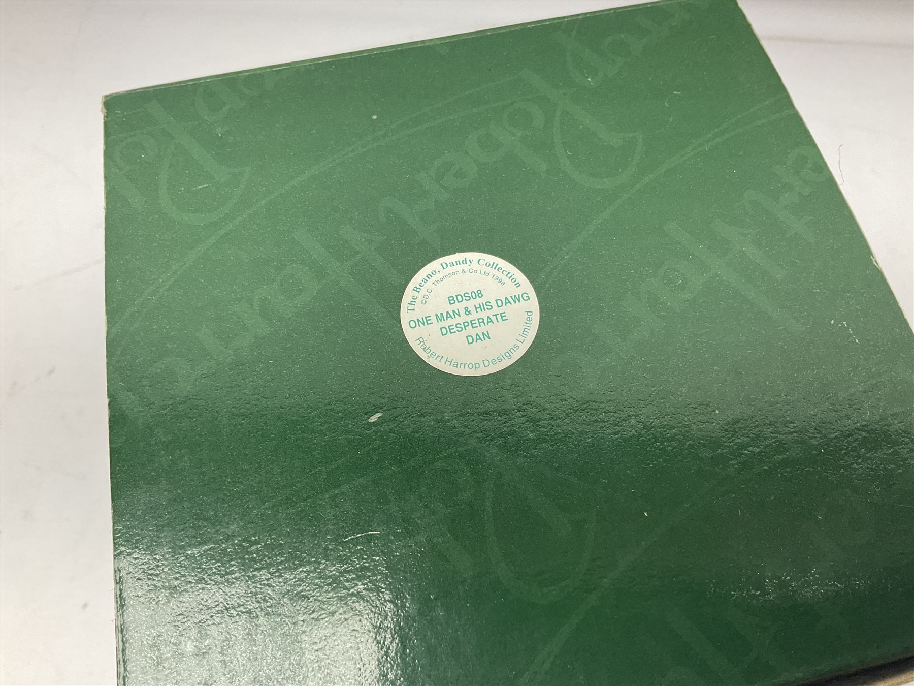 Eleven Robert Harrop figures from the Beano Dandy collection, comprising One Man & His Dawg BDS08, Picnic Desperate Dan BDS04, Fatty BD07, Desperate Dan BD03, Roger the Dodger BD20, Dennis the Menace BD01, Beryl the Peril BD05, Minnie the Minx BD04, Surfing BP03, two Spotty BD16, together with a Genuine Beano Ware lidded box (12)