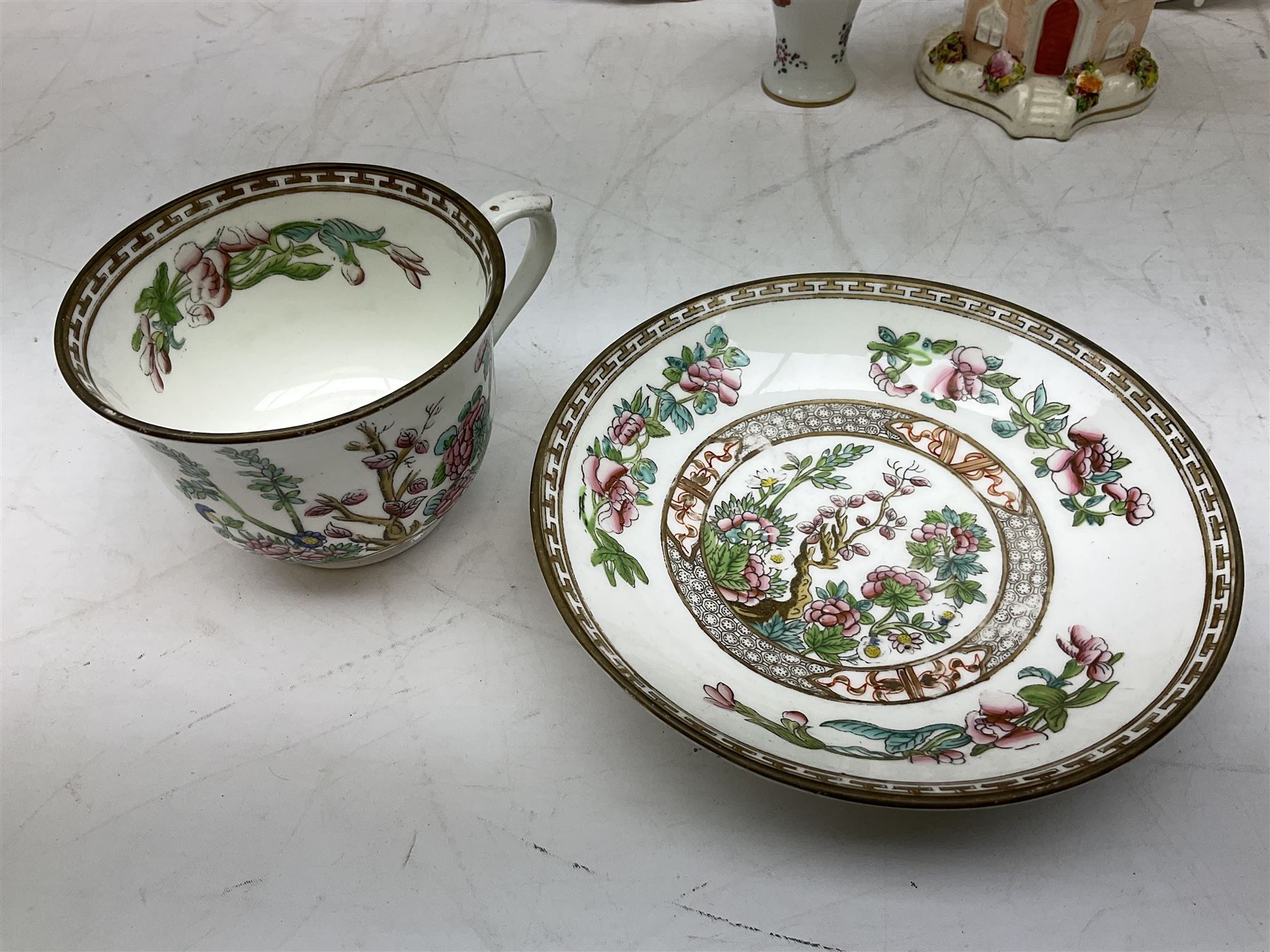 Mid 18th century Chelsea plate with gold anchor mark beneath, decorated with green floral sprays upon plain ground, the moulded cavetto shaped border with gilt rim, (A/F), D22cm, together with early 20th century Adams Tunstall Tokio pearlware slop bowl, Spode plate decorated in the Imari type pallette, with impressed and printed marks beneath, 19th century Indian Tree pattern breakfast cup and saucer, small polychrome enamelled vase and cover in the style of Samson of Paris, with marks beneath, and a pastille burner