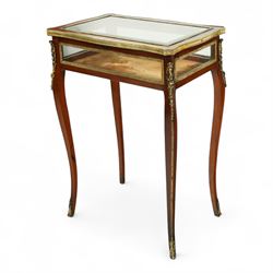 19th century, Louis XV style, bronze mounted bijouterie table, the hinged rectangular bevelled glass top with gilt bronze foliate beading, side glass panels  and plush-lined velvet interior, raised on cabriole legs, with gilt bronze masks and sabots