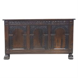 17th century design panelled oak blanket chest, hinged top above carved triple arch frieze, raised on individual carved claw feet