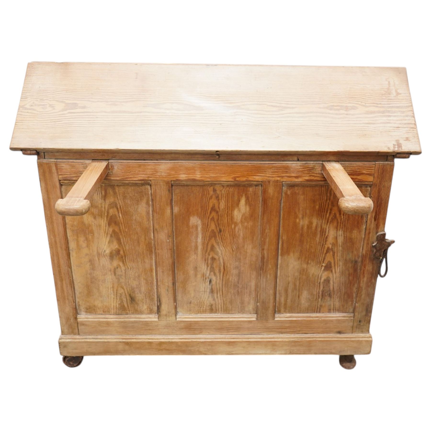 Musgrave & Co Ltd (Belfast) - late 19th century pine saddle horse, with three drawers to one end and cupboard door to the other, the hinged top opening to form a table, the cast iron plaque bears the Royal coat of arms and maker's name