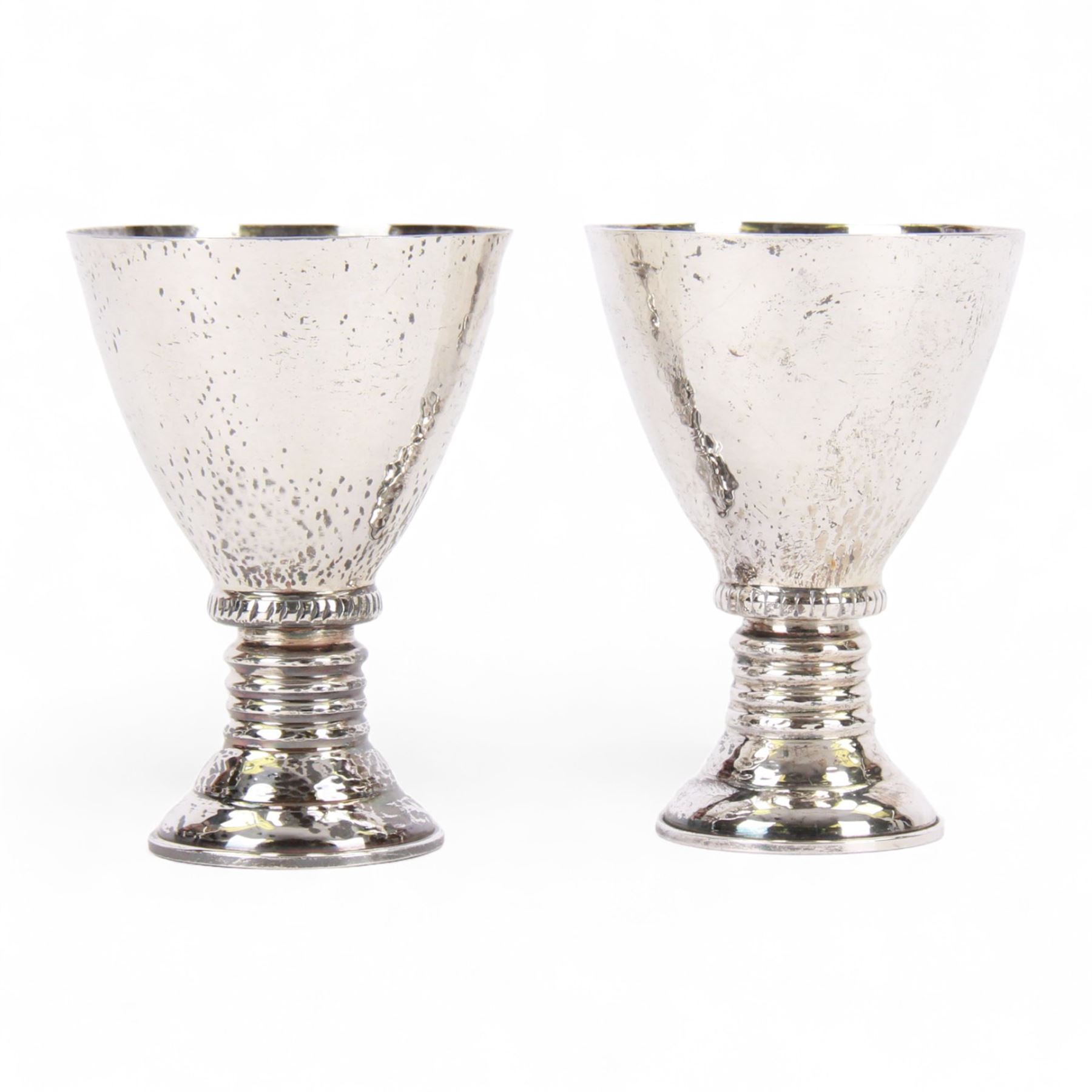 Pair of 20th century Greek silver metal goblets, each with planished tapering bowl upon a knopped stem and stepped spreading foot, marked Lalaounis 925, H10.5cm
