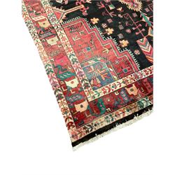 Persian Hamadan rug, the field decorated all-over with stylised plant and flower head motifs, lozenge pole medallion, repeating triple band border 