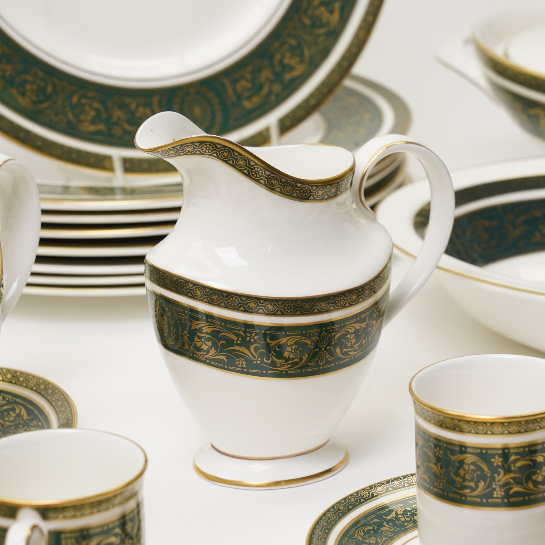 Royal Doulton Vanborough pattern part dinner service, comprising two covered vegetable dishes, open vegetable dish, eight dinner plates, oval serving dish, six soup bowls and two further bowls, eight side plates and eight dessert plates, six coffee cans and saucers, milk jug and a gravy boat and stand