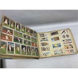 Three albums of cigarette cards including Wills Recruiting Posters, Military Motors and Allied Army Leaders, cricketers etc; another album containing a large quantity of laid-in cigarette cards; and an album of thirty-seven postcards of dogs by Mac (5)