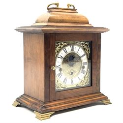 Late 20th century walnut cased bracket clock, sarcophagus top with loop handle, the brass dial with penny moon phase, Roman chapter ring and decorated with ornate cast metal spandrels, triple train driven movement by 'Franz Hermle', quarter chiming
