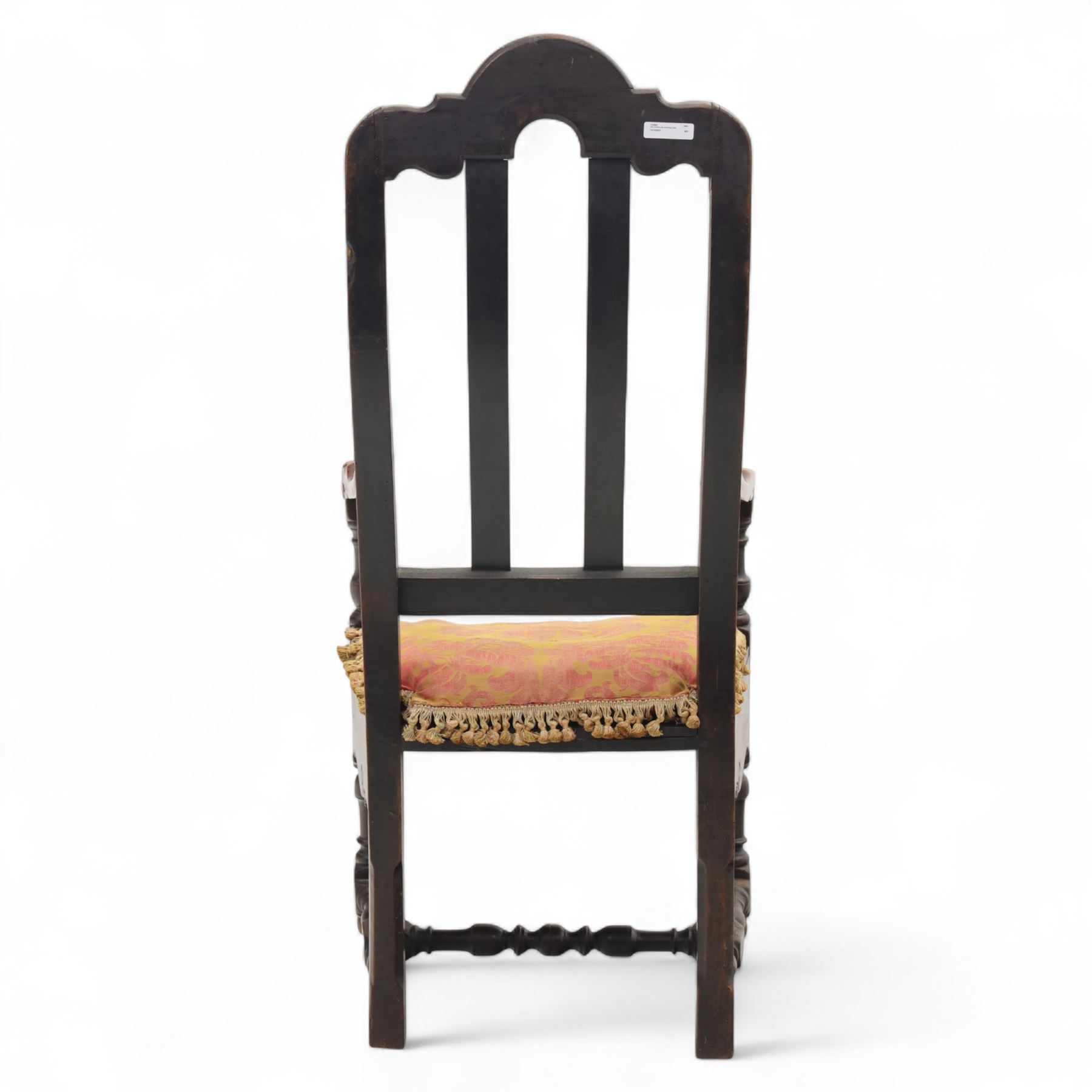 18th century oak provincial armchair, arched and carved cresting rail above triple splat back, shaped arms on turned supports, stuff-over seat upholstered in damask fabric, carved front frieze on turned legs united by stretchers
