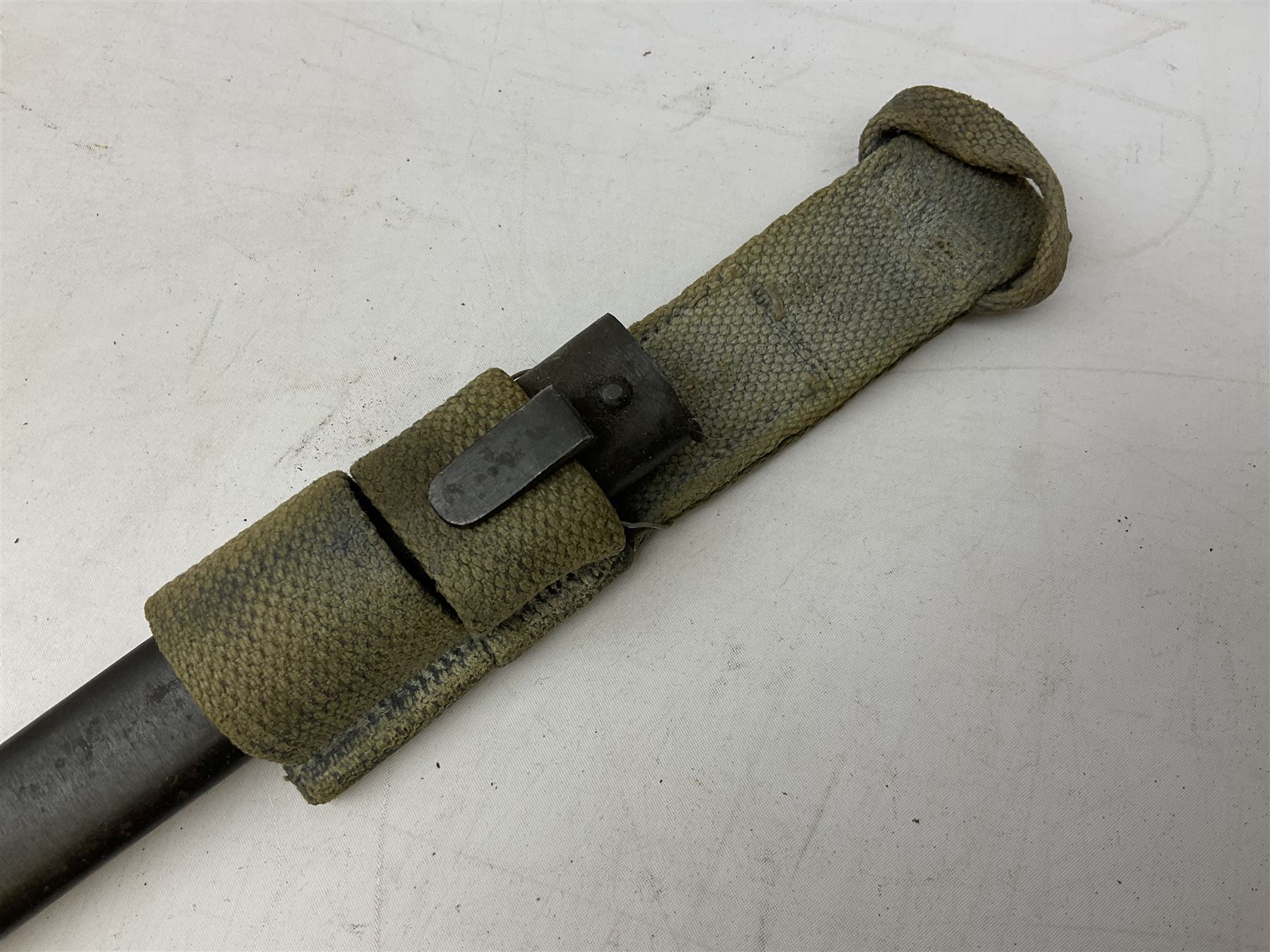 Italian Model 1891 Carcano knife bayonet with 30cm fullered steel blade, the cross-piece stamped VL1110; in steel scabbard with webbing frog L43cm overall; and another Italian fighting knife/bayonet in brass bound leather scabbard (2)