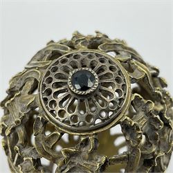 Modern silver limited edition Easter egg, no. 70/500, the gilt openwork body decorated with daffodils and detachable cover with pierced circular panel set with a single faceted blue stone, opening to reveal a gilt interior, upon silver stand with three scrolling pad feet, each hallmarked St James House Company, London 1980, height including stand 8cm