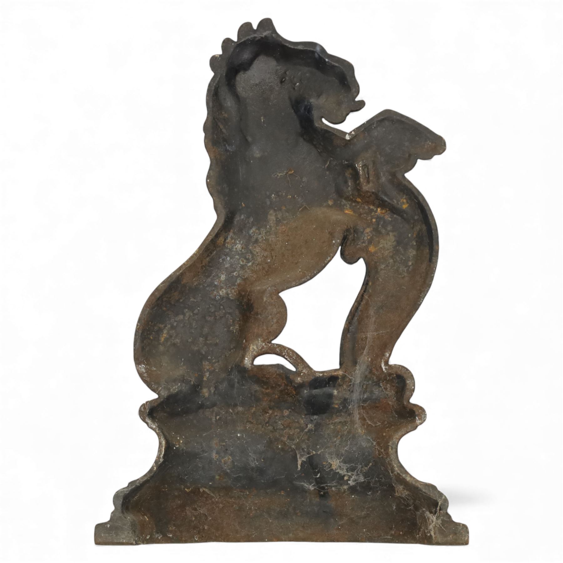 Victorian cast iron figural doorstop in the form of a lion, depicted seated with curled tail and detailed mane, raised foreleg resting against a scroll motif, set on an integral stepped base with moulded edges and foliate ornament