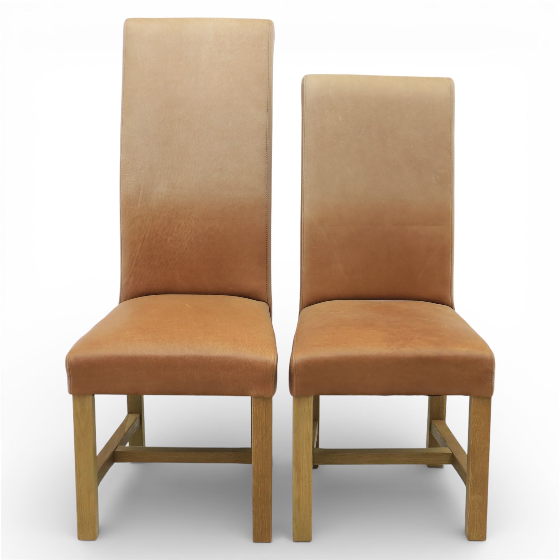 Modern large oak plank top dining table and twelve brown leather high back chairs, table of rustic construction five solid planks with exposed supports, the chairs in brown leather hide with ten standard height and a pair of taller chairs for the foot and head of the table