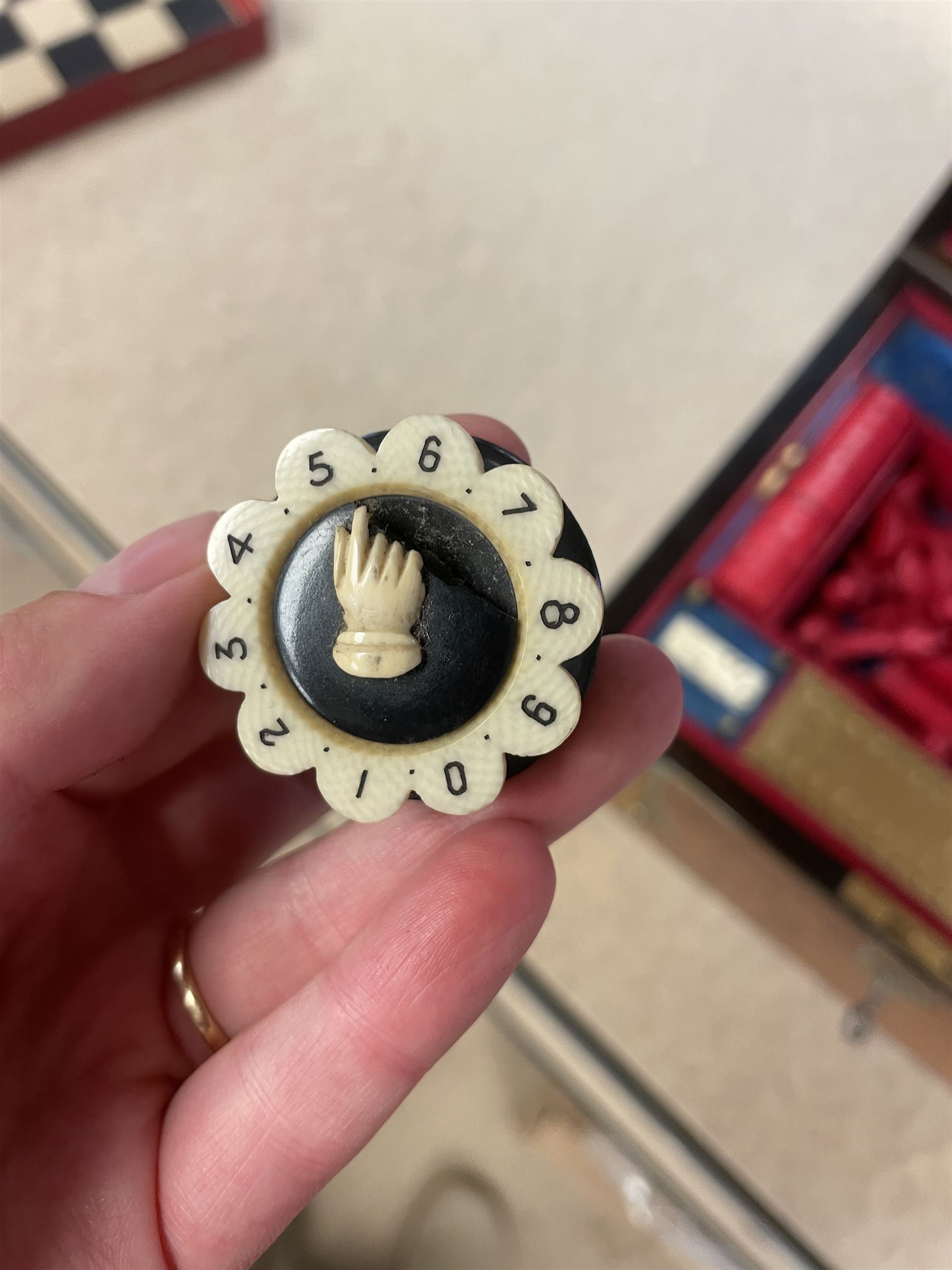 19th century walnut and brass bound games compendium box, painted to enhance the grain, of rectangular form, the hinged opening cover with rounded sides, central brass cartouche with engraved lion crest, and brass riveted straps, opening to reveal a red leather and blue silk lined compartmented interior, with fold-down games board, and lift-out tray containing playing cards, ebony turned dice towers, white and red stained bone draughts, and chess pieces, ivory dice, and ivory and ebony whist markers, and brass bezique board, cribbage board and markers, H15cm W32cm D24cm
This lot has been registered for sale under Section 10 of the APHA Ivory Act