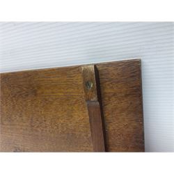 Arts and Crafts oak stand by Arthur Simpson of Kendal, of rectangular form with central hammered pewter panel, surrounded by a border with carved foliate corners, upon two bar supports, bearing label detailed 