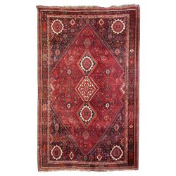 Large Persian Shiraz crimson ground carpet, the busy field decorated with a geometric pole...