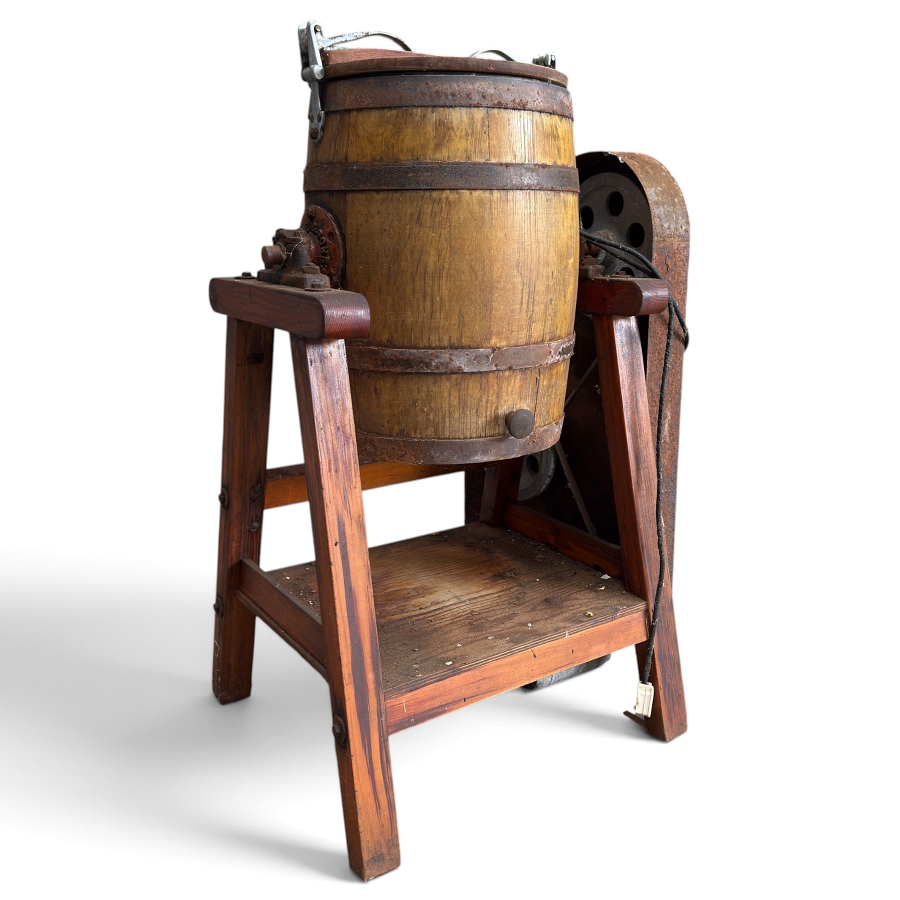 Two early 20th century dairy equipment items: Waide & Sons, Leeds – oak barrel butter churn with iron bands, later converted to electric operation, on trestle stand (W71cm H115cm); Lister – ‘Ball Bearing’ cast iron cream separator, with hopper and foot pedal, in red-painted finish (W47cm H49cm)