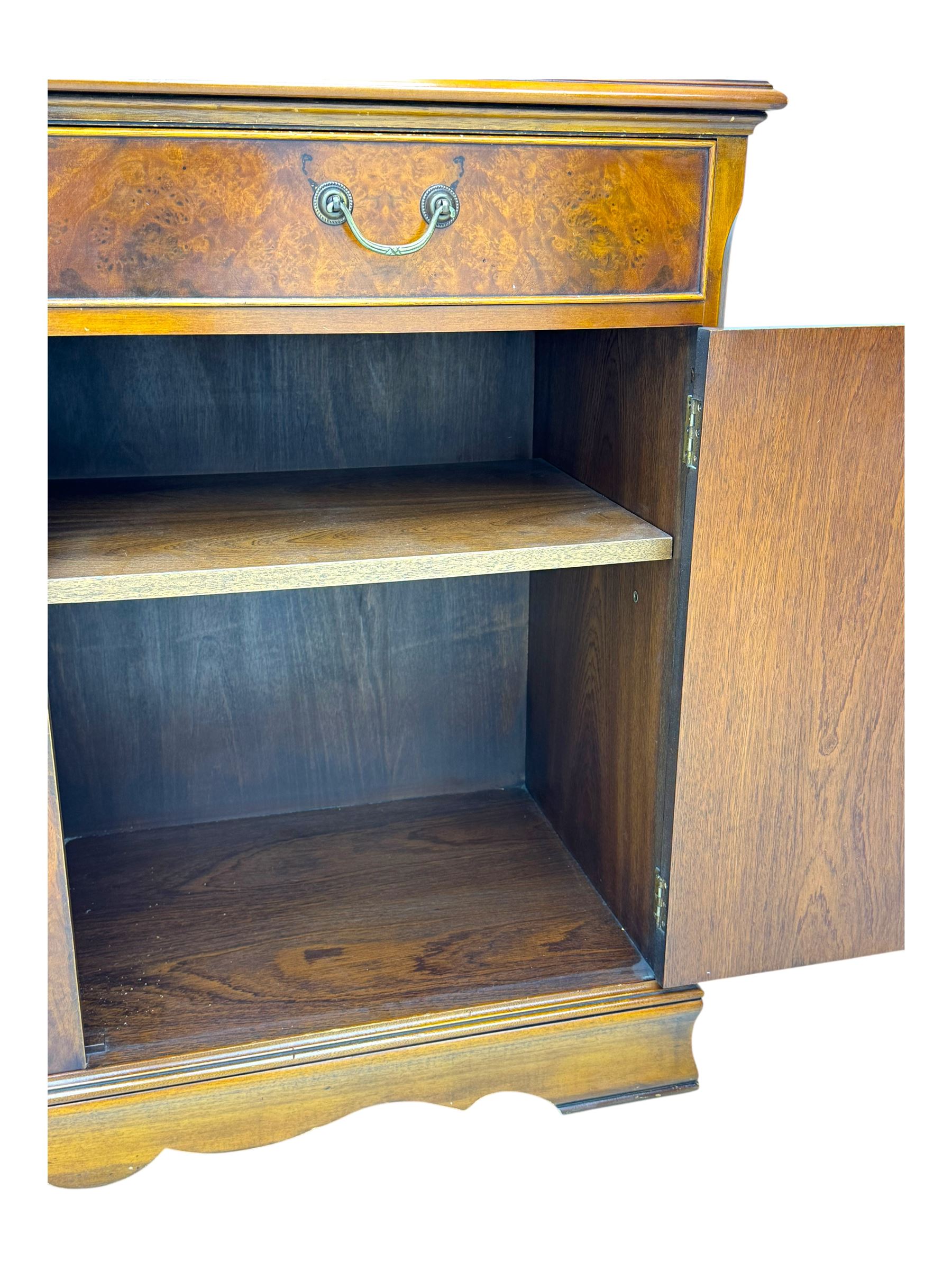 Ian Smith Furniture - Georgian design walnut bookcase on cupboard, projecting cornice above a pierced geometric frieze, featuring two astragal-glazed doors enclosing two adjustable shelves, the base with two drawers above a double cupboard, on a shaped plinth base