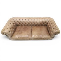 Distinctive Chesterfield - Chesterfield upholstered in taupe leather, deep button back and arms, loose seat cushions, raised on dark stained supports 