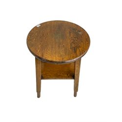 Early to mid-20th century oak tavern table, circular top splayed square supports with peg feet joined by square under tier  