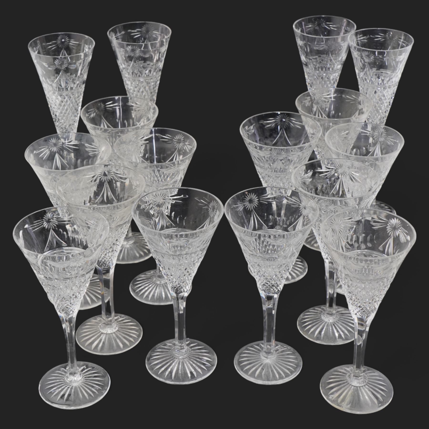 Stuart crystal 'Beaconsfield' pattern drinking glasses comprising twelve wine glasses and four champagne flutes (16)